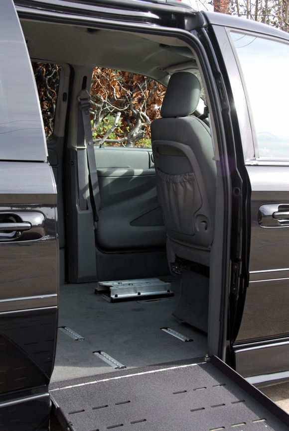 Door open showing wheelchair tie down / clamp